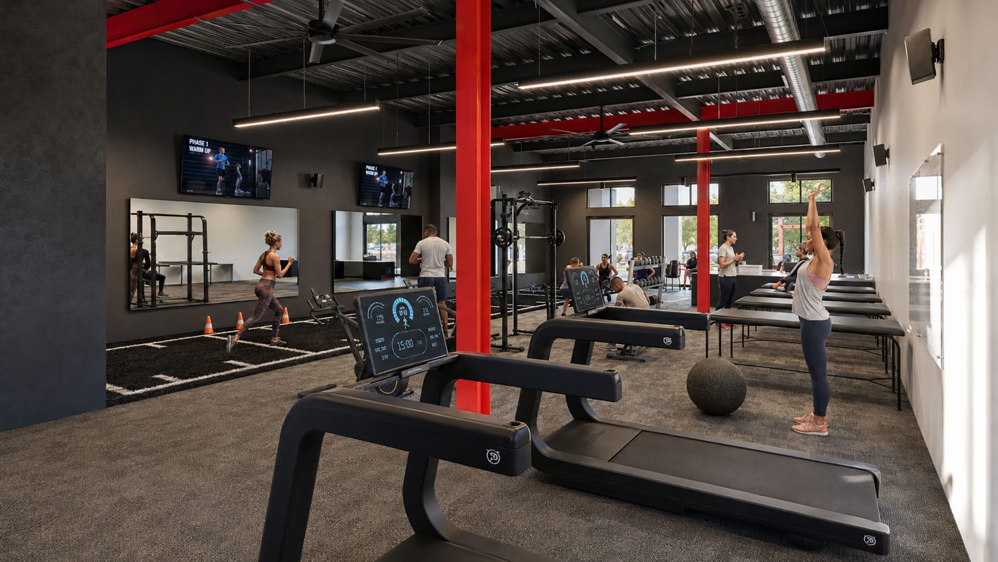 Cardio area with treadmills and red structural columns at Architech Sports in Charlotte, NC, by Ossa Studio