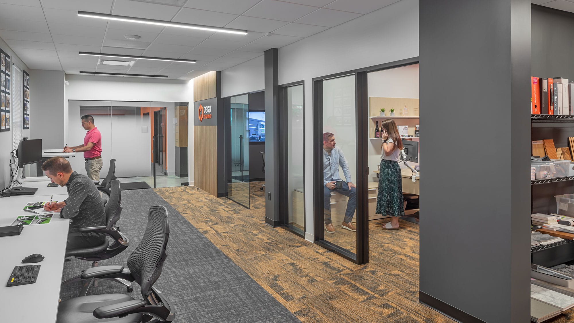 Open office desks and glass office fronts at Hedgemore Flex in Charlotte, NC, with linear LED lighting by Ossa Studio