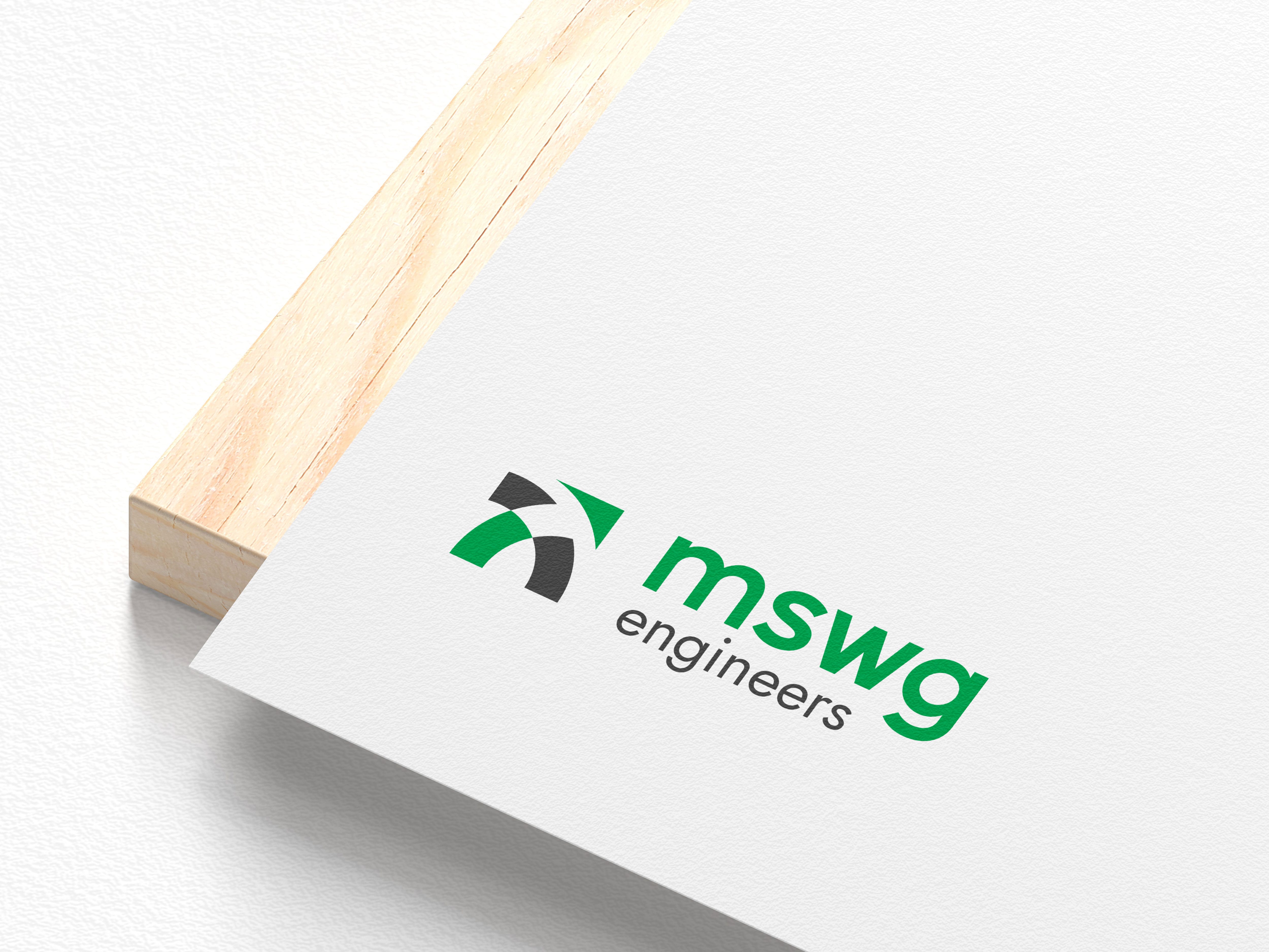 New MSWG Engineers logo on white card stock resting on a wood board, part of the Charlotte, NC rebrand by Ossa Studio