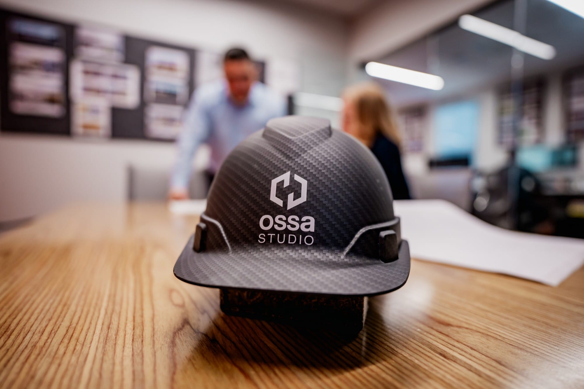 Ossa Studio hard hat on the conference table during a project review