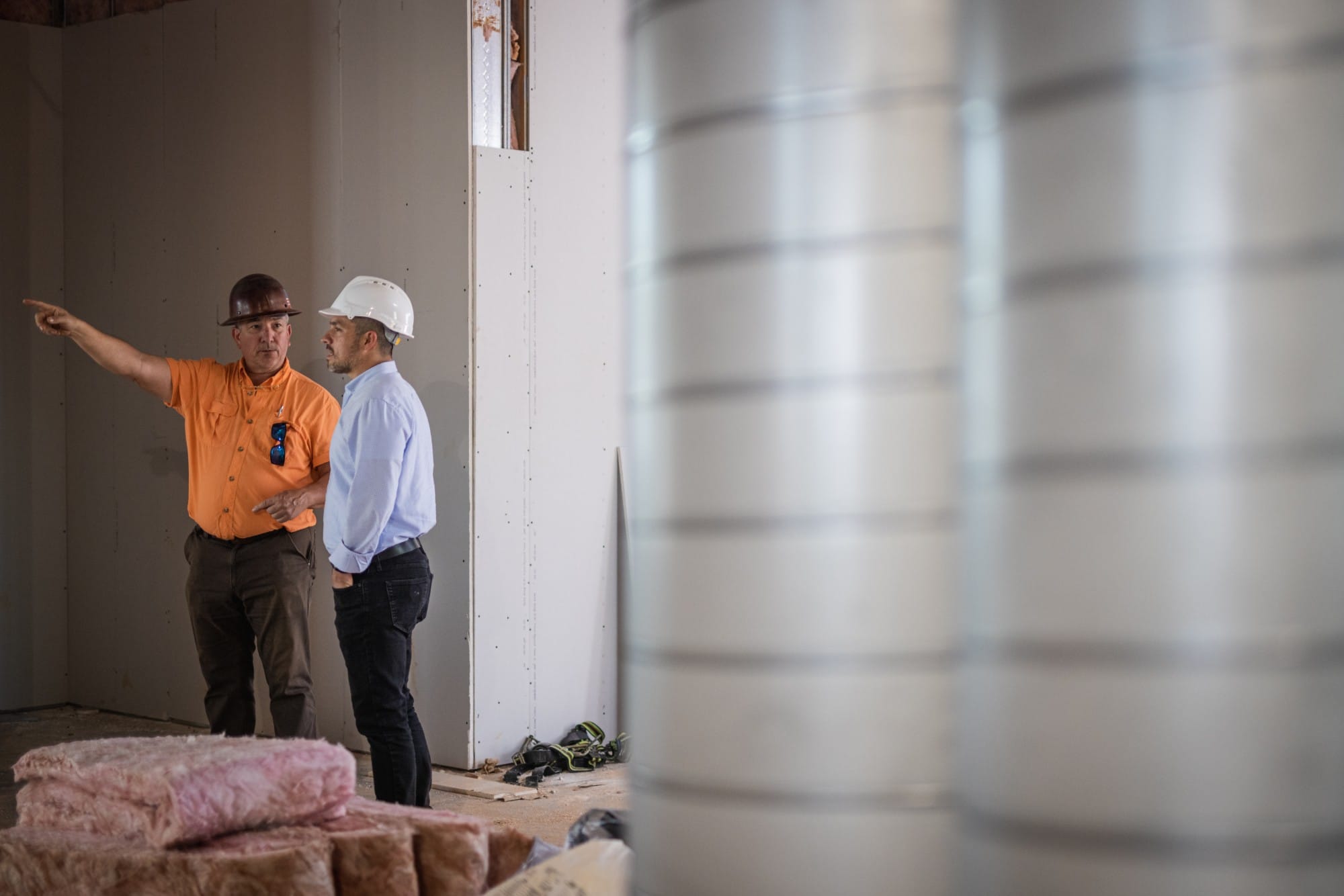 Jack Ossa walking an Ossa Studio construction site with the contractor