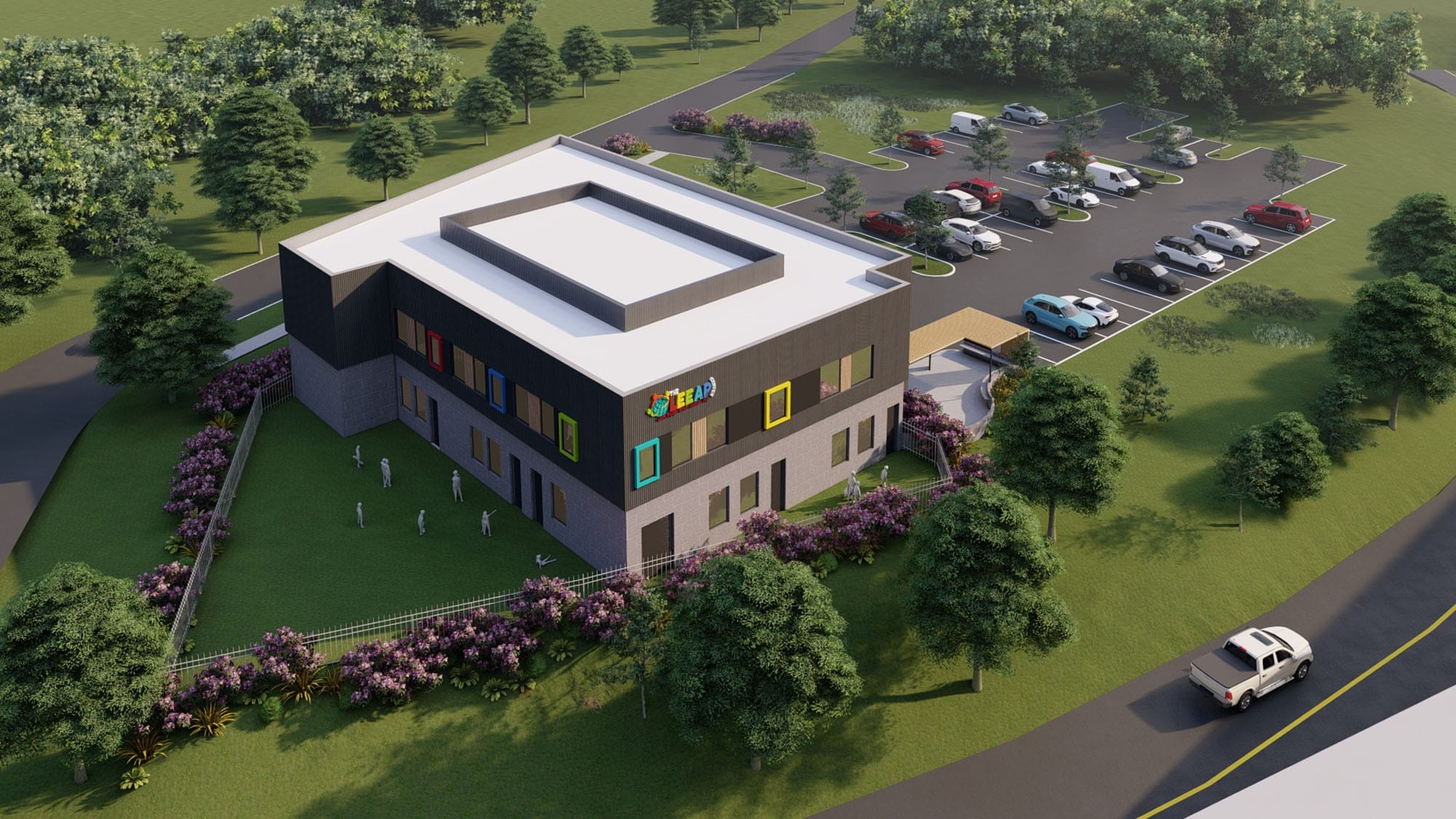 Aerial rear view of The LEEAP Center in Charlotte, NC with dark cladding, colorful window frames and an outdoor play lawn by Ossa Studio