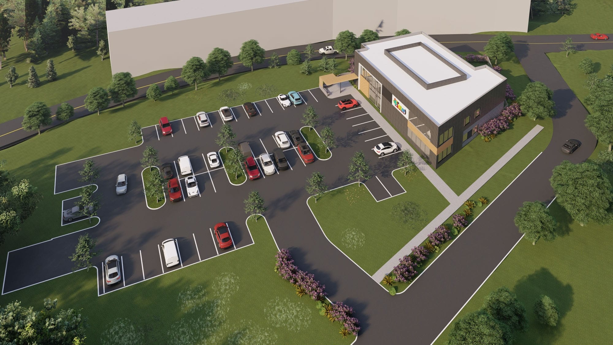 Aerial view of The LEEAP Center site in Charlotte, NC showing the two-story building, parking lot and landscaped grounds by Ossa Studio