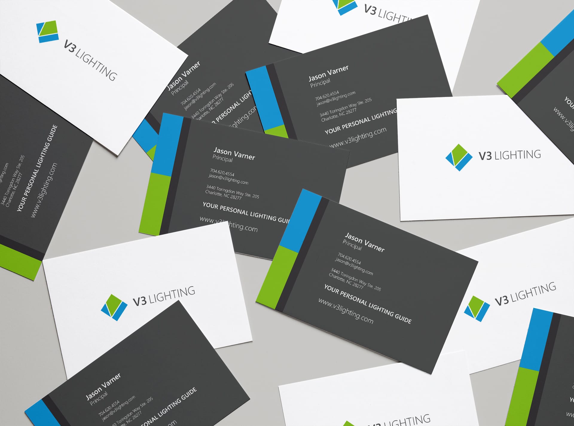 V3 Lighting business cards in dark gray with blue and green bands and the tagline Your Personal Lighting Guide, by Ossa Studio